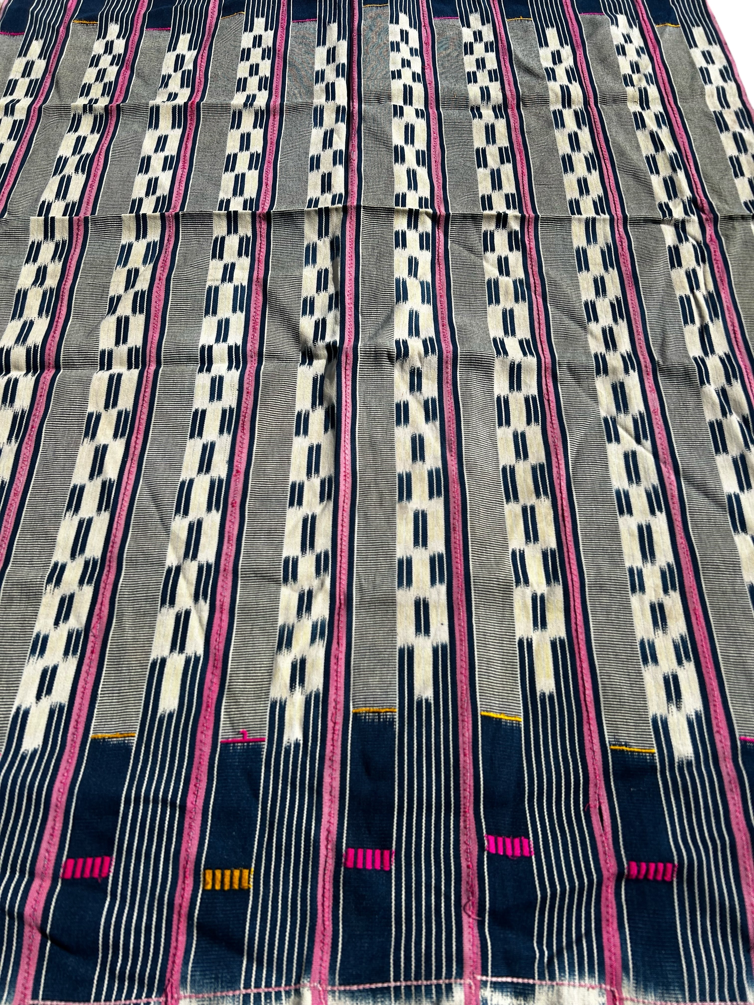 Fabric with a striped pattern featuring pink, white, and navy blue on a gray background.