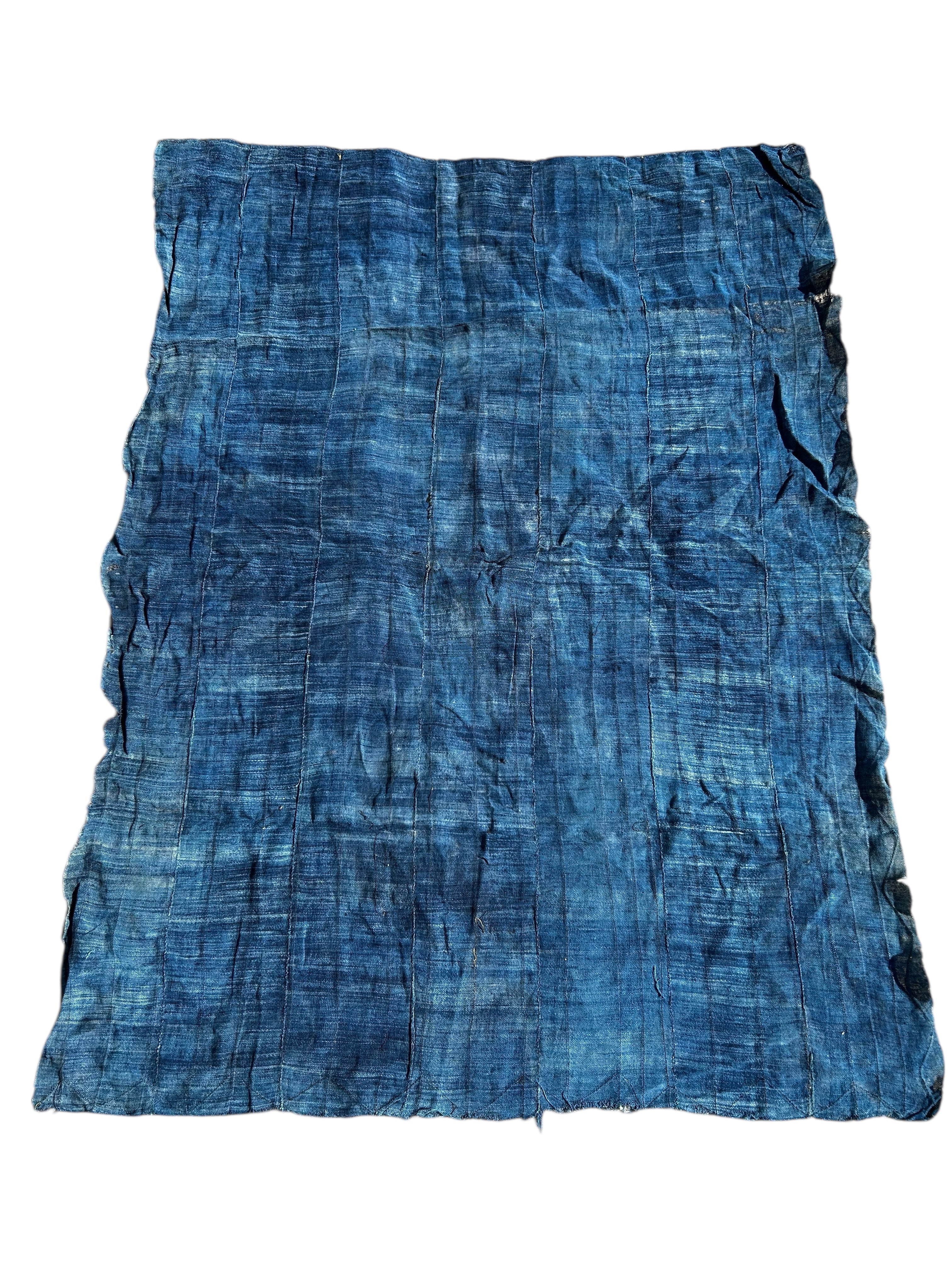 Close-up of indigo-dyed cotton textile showing natural wear and texture