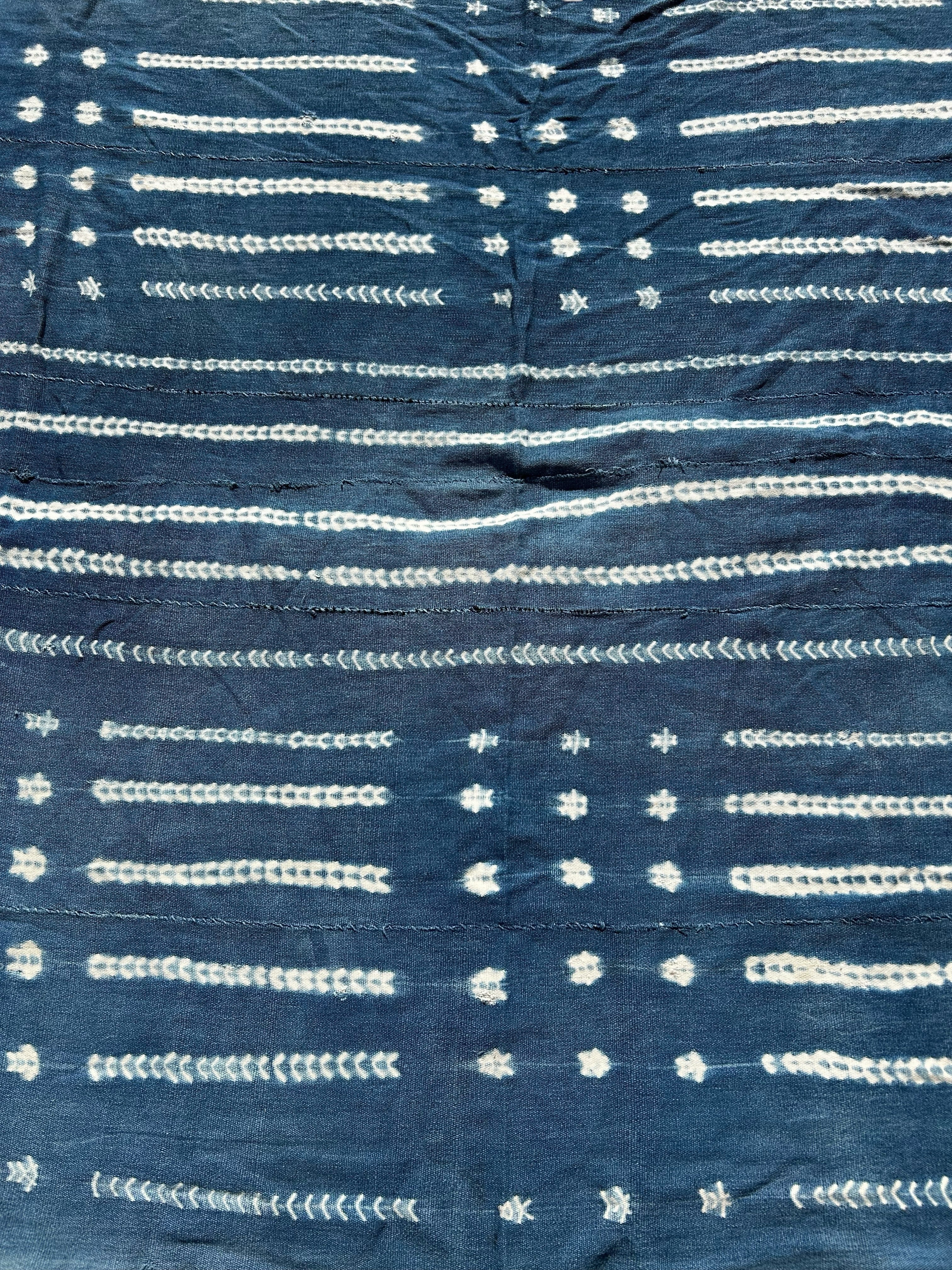 Close-up of indigo-dyed cotton textile showing resist details and texture
