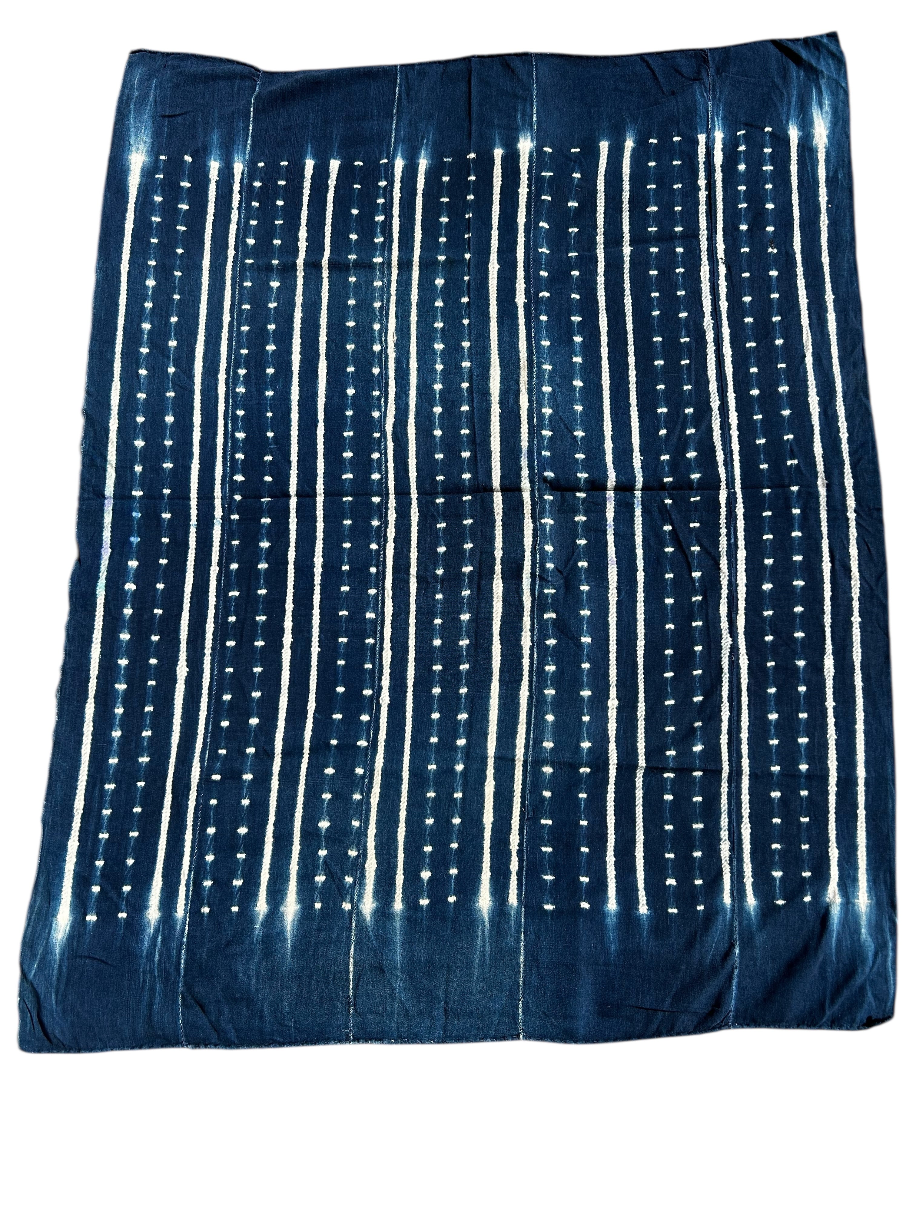Blue fabric with white vertical patterns on a white background