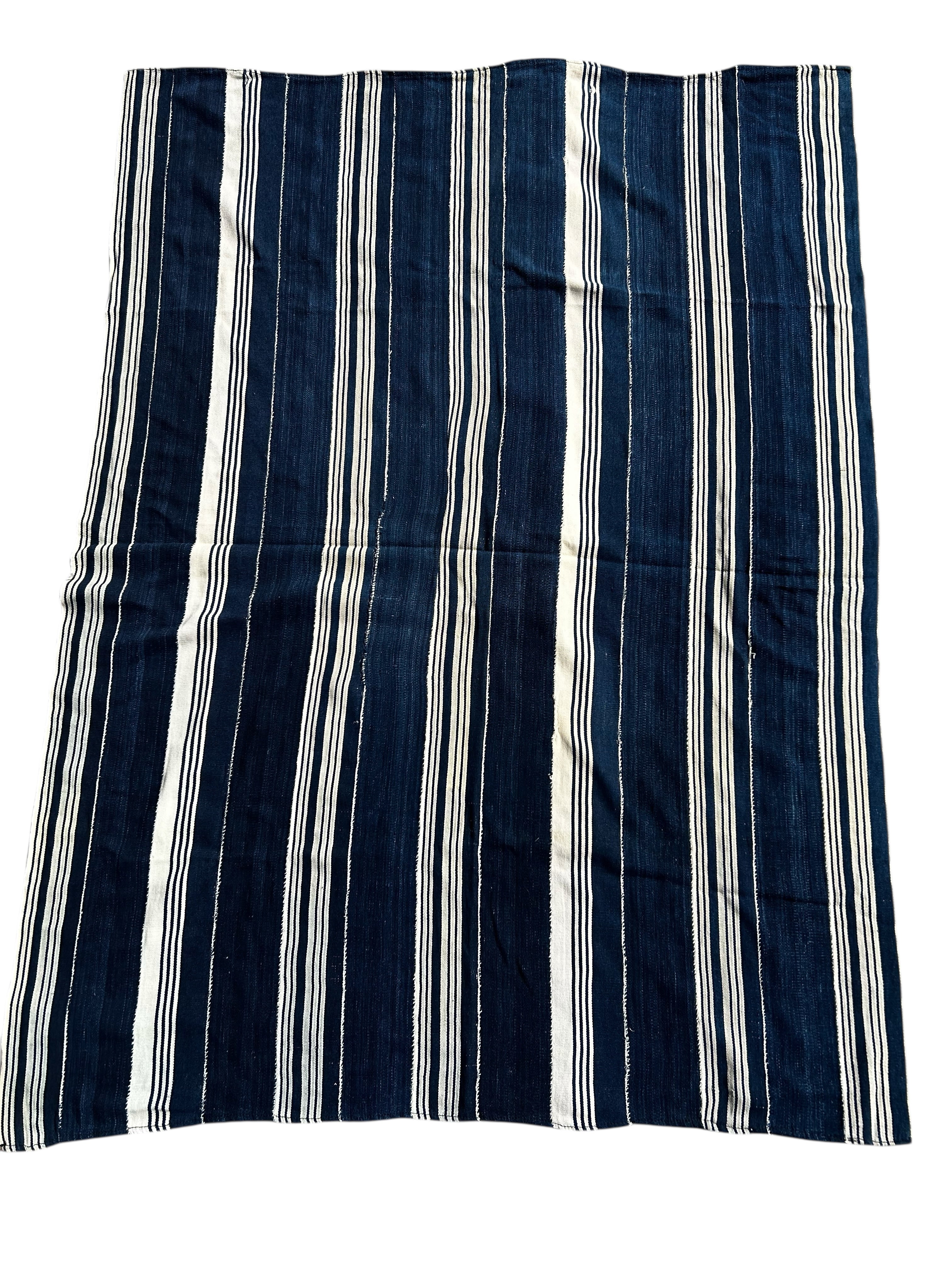 Striped fabric with blue and white vertical stripes on a white background