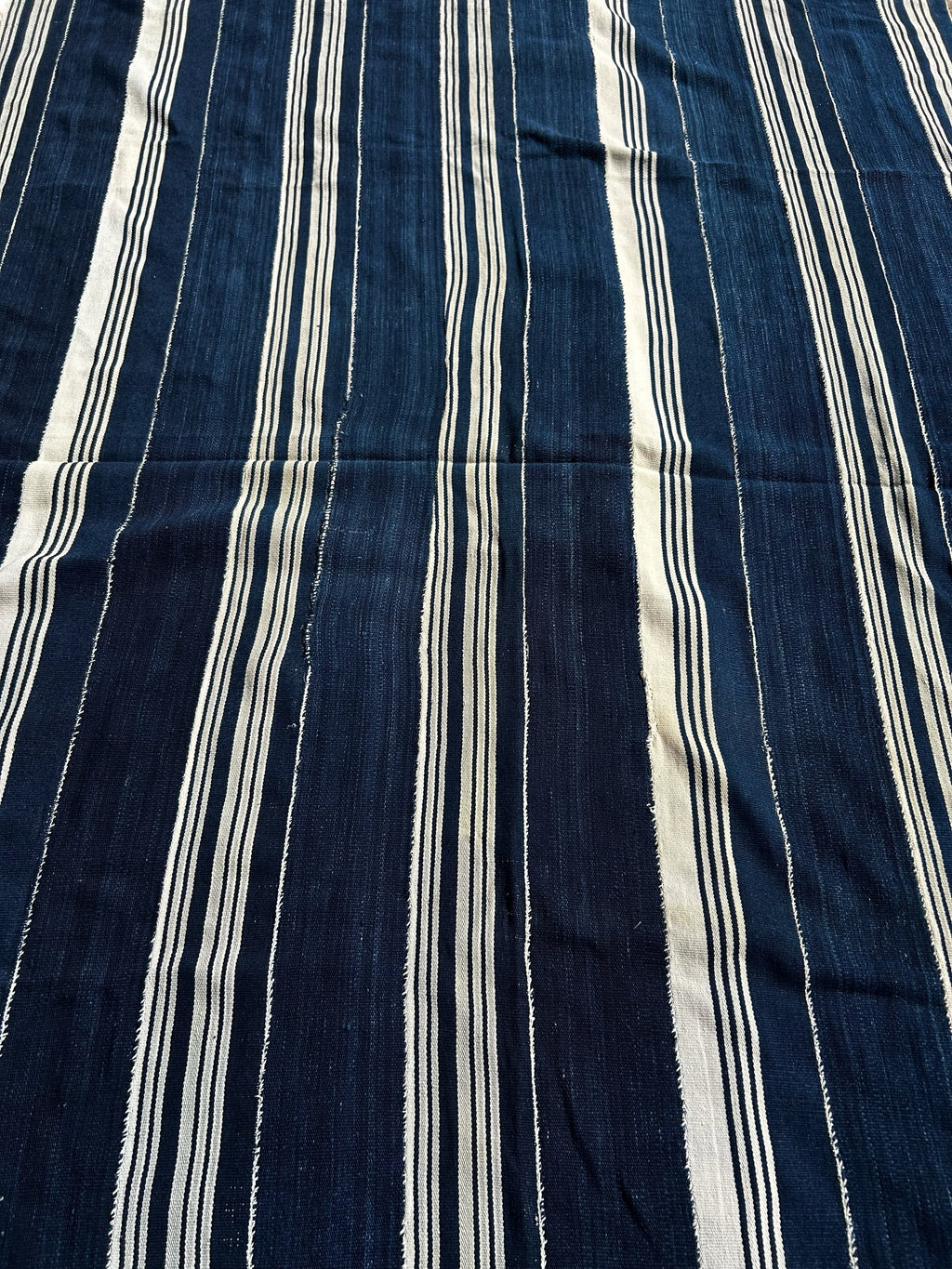 Navy blue fabric with white vertical stripes