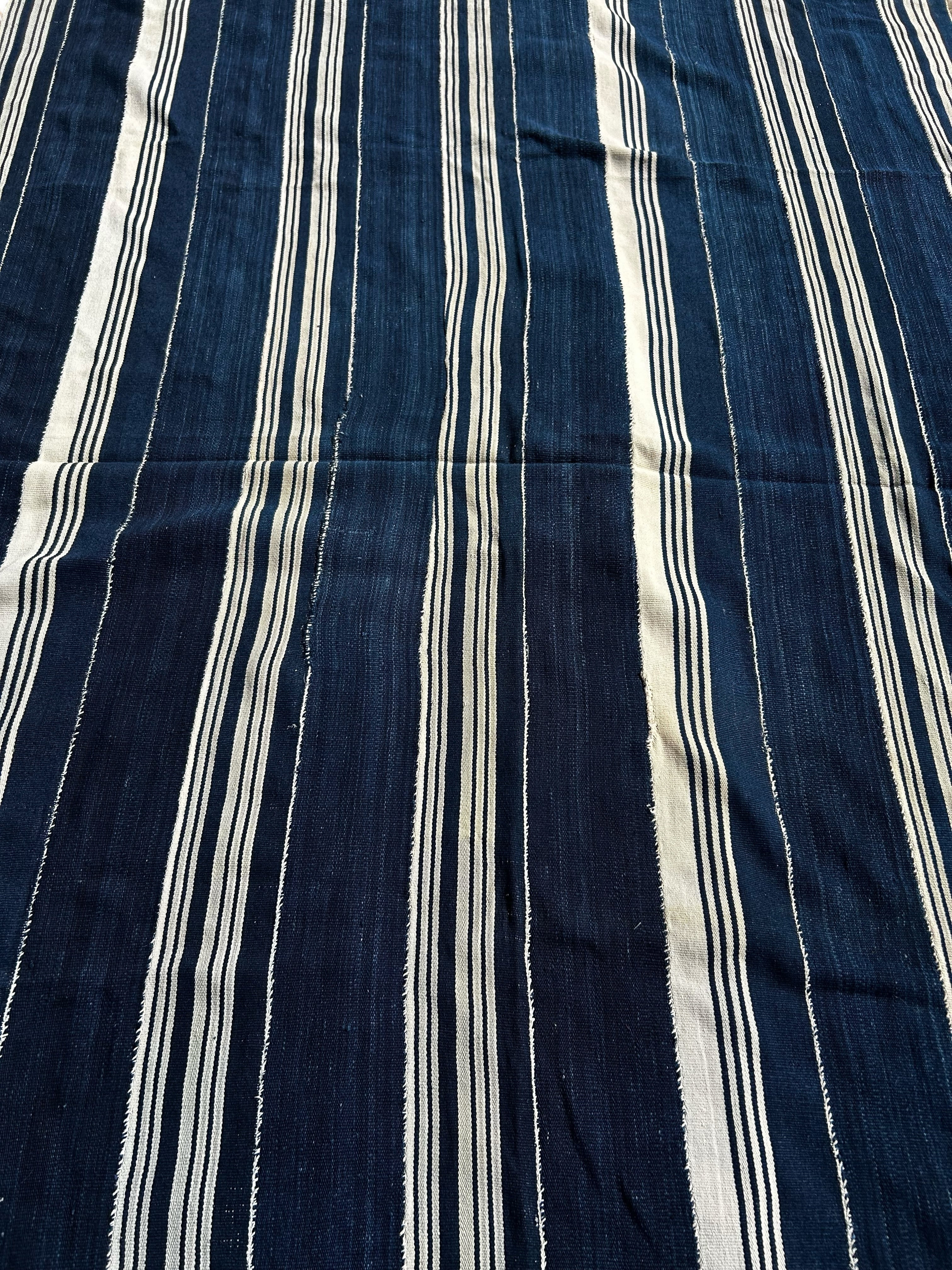 Navy blue fabric with white vertical stripes